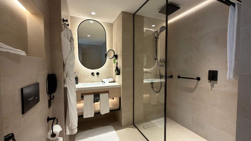 Modern hotel bathroom with glass shower and premium amenities